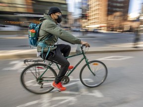 A cyclist wears a mask while on the de Maisonneuve bike path in Montreal.