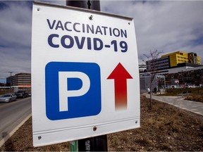 A sign directs drivers to a COVID-19 vaccination clinic at the MUHC's Glen Campus in Notre-Dame-de-Grâce on Wednesday, April 7, 2021.