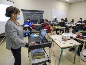 Masked teacher Yseult Blaise conducts French class at John F. Kennedy High School in Montreal Tuesday November 10, 2020.