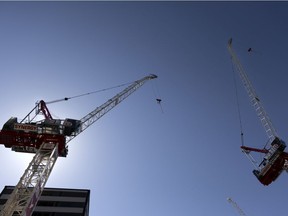 Construction cranes tower above as another condo tower is built in the Cartier des spectacles, in Montreal, on Saturday, April 10, 2021.