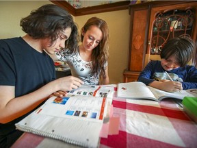 Paula Girolami does school work with her sons Renato, left, and Domenico at their home in Lachine on April 7, 2021. Girolami chose to homeschool her sons because of COVID-19 fears.