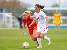 Canada's Jesse Fleming, right, dribbles the ball against Wales midfielder Ceri Holland, left, in an exhibition game in Cardiff, Wales, on April 9, 2021. Canada won 3-0.