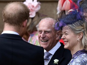 Britain's Prince Philip, Duke of Edinburgh talks to Prince Harry after the wedding of Lady Gabriella Windsor and Thomas Kingston at St George's Chapel, in Windsor Castle on May 18, 2019.