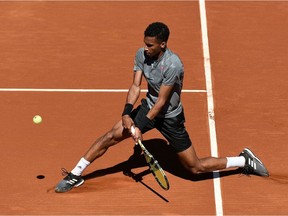 Montreal's Félix Auger Aliassime returns the ball to Greece's Stefanos Tsitsipas during their ATP Barcelona Open tennis tournament singles quarter-final match at the Real Club de Tenis in Barcelona on April 23, 2021.