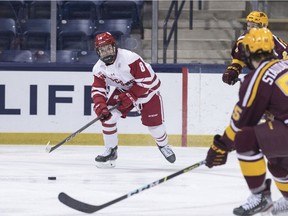 Wisconsin forward Cole Caufield (8) advances the puck during the championship game against Minnesota in the Big Ten tournament on March 16, 2021, in South Bend, Ind.