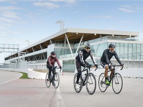 Cyclists ride along the paddocks at Circuit Gilles Villeneuve in Montreal, on Wednesday, April 14, 2021. Governments are evaluating whether or not to approve and fund the Canadian Grand Prix scheduled for June 13 amid the COVID-19 pandemic.