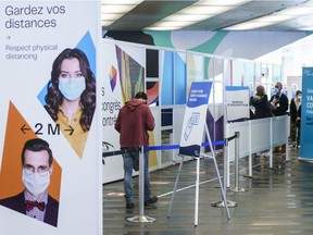 A patient walks into a COVID-19 vaccination clinic at the Palais des congrès on Wednesday. To this point, Quebec has managed to vaccinate almost 20 per cent of its population.