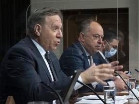 Quebec Premier François Legault speaks during a news conference on the COVID-19 pandemic, Tuesday, April 27, 2021 at the legislature in Quebec City, as Health Minister Christian Dubé looks on.
