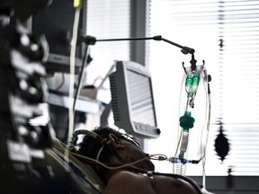 A patient infected with COVID-19 is cared by extracorporeal membrane oxygenation (ECMO) at the AP-HP Georges Pompidou European Hospital, on April 6, 2021 in Paris.