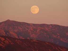 Though April's Pink Moon won't have actually have a pink hue, the Old Farmer's Almanac says it will still be a sight to see.