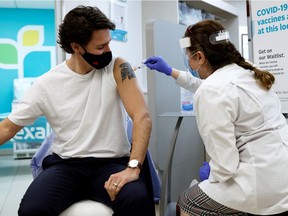 Canada's Prime Minister Justin Trudeau is inoculated with AstraZeneca's vaccine against coronavirus disease (COVID-19) at a pharmacy in Ottawa, Ontario, Canada April 23, 2021.