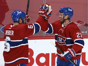 Montreal Canadiens' Eric Staal, right, celebrates his winning goal with teammate Shea Weber during overtime in NHL hockey action against the Edmonton Oilers in Montreal April 5, 2021.