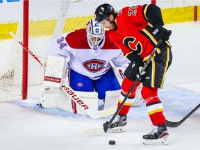 Canadiens goaltender Jake Allen guards his net as Flames' Elias Lindholm tries to score during the first period at Scotiabank Saddledome in Calgary on Friday, April 23, 2021.
