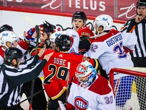 Apr 24, 2021; Calgary, Alberta, CAN; Calgary Flames center Elias Lindholm (28) gets into a scrum with Montreal Canadiens defenseman Karl Alzner (27) during the third period at Scotiabank Saddledome. Mandatory Credit: Sergei Belski-USA TODAY Sports