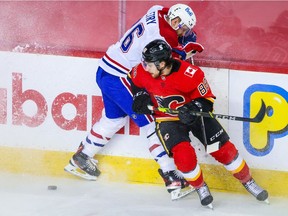 Calgary Flames left wing Andrew Mangiapane (88) and Montreal Canadiens defenseman Jeff Petry (26) battle for the puck during the second period at Scotiabank Saddledome. Mandatory Credit: Sergei Belski-USA TODAY Sports