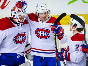 Canadiens' Tyler Toffoli is flanked by goalie Jake Allen and rookie Cole Caufield after Monday night's win over the Calgary Flames.