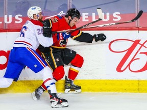 Flames' Dillon Dube (29) and Canadiens defenceman Jeff Petry battle for the puck during the second period at Scotiabank Saddledome in Calgary on Friday, April 23, 2021.