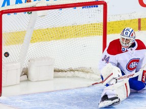 Canadiens goalie Jake Allen watches winning goal by the Flames’ Sean Monahan go into the net during Calgary’s 4-2 victory Friday night.