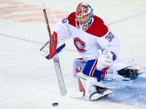 Canadiens goaltender Cayden Primeau makes a save against the Flames during the first period at Scotiabank Saddledome in Calgary on Saturday, April 24, 2021.
