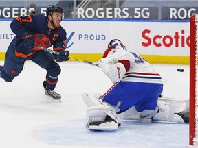 Oilers superstar Connor McDavid rifles a shot past Canadiens goaltender Jake Allen during the third period at Rogers Place Monday night.