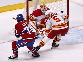 Canadiens' Tyler Toffoli beats Flames goalie Jacob Markstrom and defenceman Mark Giordano to score the winning goal April 16 at the Bell Centre.