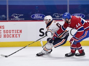Edmonton Oilers forward Connor McDavid goes by Montreal Canadiens defenceman Joel Edmundson during the second period at the Bell Centre on April 5, 2021.