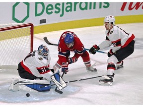 Senators goaltender Anton Forsberg makes a save against Canadiens' Brendan Gallagher (11) as Ottawa defenceman Artem Zub (2) assists during the first period at Bell Centre on Saturday, April 3, 2021.