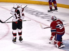 The Ottawa Senators’ Nick Paul (13) congratulates teammate Connor Brown after he scored on Canadiens goalie Carey Price in game Saturday night at the Bell Centre.