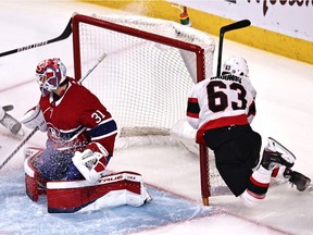 Ottawa Senators' Evgenii Dadonov (63) crashes into Canadiens goaltender Carey Price's net during the first period at Bell Centre on Saturday, April 17, 2021, in Montreal.