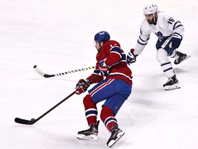 Montreal Canadiens right wing Josh Anderson (17) plays the puck against Toronto Maple Leafs centre Alexander Kerfoot (15) at the Bell Centre.