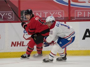 Ottawa Senators defenseman Mike Reilly (5) and Montreal Canadiens right wing Brendan Gallagher (11) chase the puck in the first period at the Canadian Tire Centre April 1, 2021.