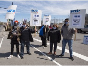 Port of Montreal workers picket on the second day of their strike Tuesday, April 27. The workers have been without a contract for more than two years.