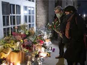Quebec City Mayor Régis Labeaume brings flowers at a vigil to honour Suzanne Clermont, who was stabbed to death on Halloween night 2020 by a man with a sword.