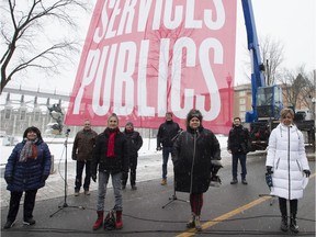 Union leaders stand in front of a banner as they demonstrate on Nov. 25, 2020 in Quebec City. From left, first row: Sonia Ethier of the CSQ, Line Lamarre of the SPGQ, Andrée Poirier of the APTS, Nancy Bédard of the FIQ. Second row: Daniel Boyer of the FTQ, Sylvain Mallette of the FAE, Jacques Létourneau of the CSN, Christian Daigle of the SFPQ.