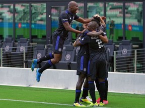CF Montréal forward Mason Toye (13) celebrates with teammates after scoring a goal against Toronto FC during the first half at DRV PNK Stadium in Fort Lauderdale, Fla., on Saturday, April 17, 2021.