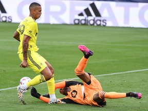 Nashville SC forward Jhonder Cadiz (99) has the ball knocked away by CF Montreal goalkeeper Clément Diop before getting a shot on goal during the first half at Nissan Stadium in Nashville, Tenn., on Saturday, April 24, 2021.