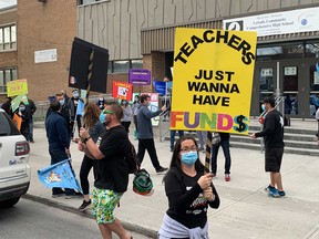 Teachers protest outside LaSalle Community Comprehensive High School during strike action April 14, 2021.