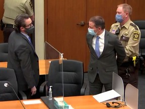 Former Minneapolis police officer Derek Chauvin is led away in handcuffs past his defense attorney Eric Nelson after a jury found him guilty of all charges in his trial for second-degree murder, third-degree murder and second-degree manslaughter in the death of George Floyd in Minneapolis, Minnesota, U.S. April 20, 2021 in a still image from video.  Pool via REUTERS