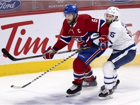 Canadiens captain Shea Weber battles Leafs' Alexander Kerfoot during acton at the Bell Centre in late April.