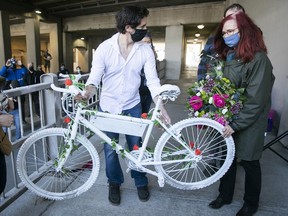 Geneviève Laborde, the mother of Mathilde Blais, receives the ghost bike after its removal from the underpass on St-Denis St. on May 2, 2021.
