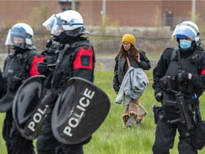 Police stood by as residents of a homeless camp on Hochelaga St. were forced to leave on Monday.