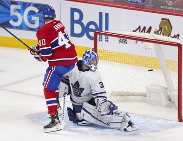 Joel Armia and Leafs goalie Jack Campbell look back at the puck after Habs Cole Caufiled scored game-winning goal during overtime in Montreal on Monday, May 3, 2021.