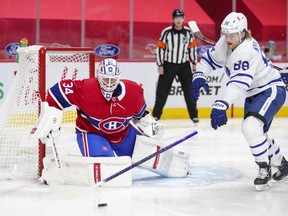 Canadiens goalie Jake Allen tracks the puck as it's chased by Toronto Maple Leafs forward William Nylander during a game this season at the Bell Centre.