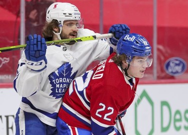 Cole Caufield holds off Toronto Maple Leafs' Timothy Liljegren during first-period action in Montreal on Monday May 3, 2021.