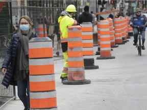 The cones are back in Montreal and a worker looks around on Mount-Royal on Tuesday May 4, 2021.
