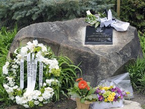 Flowers and wreath at a plaque in Senneville, commemorating the 25th anniversary of the death of Const. André Lalonde.