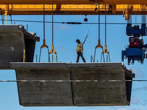 Work continues on the REM at Ste-Marie Blvd. and Highway 40 in Kirkland May 6, 2021. It takes workers about a week to install these concrete structures between three columns.