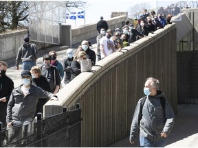 People waiting for their COVID-19 vaccine snake their way up the pedestrian ramp at Olympic Stadium on Thursday, May 6, 2021.