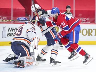 Paul Byron jostles with Edmonton Oilers' Darnell Nurse in front of Oilers goalie Mikko Koskinen during first- period action in Montreal on Monday, May 10, 2021.