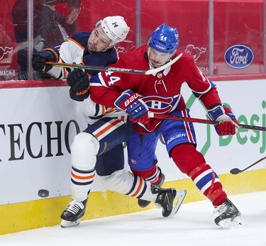 Joel Edmundson, right, knocks Edmonton Oilers' Devin Shore off the puck during second-period action in Montreal on Monday, May 10, 2021.